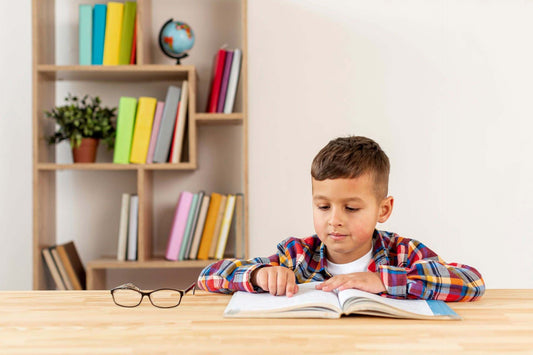 little boy learning to read a book